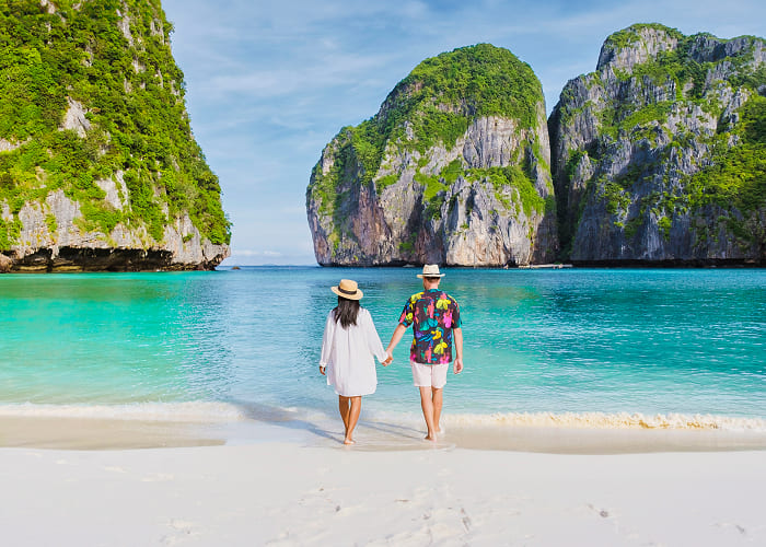 couple-in-front-of-longtail-boat-at-the-lagoon-of-2025-01-08-02-43-56-utc-1