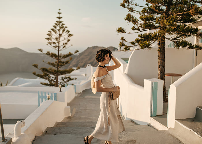 curly-brunette-woman-in-midi-beige-dress-moves-and-2024-09-24-21-32-26-utc-1